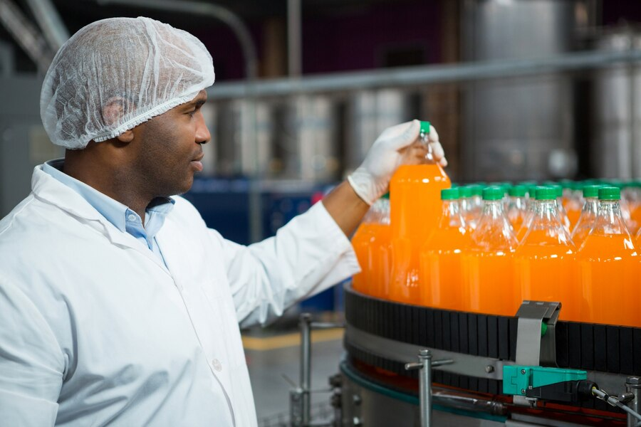 man holding a bottle at the factory